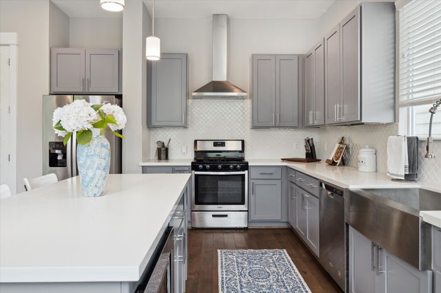 a kitchen with a sink stove and refrigerator