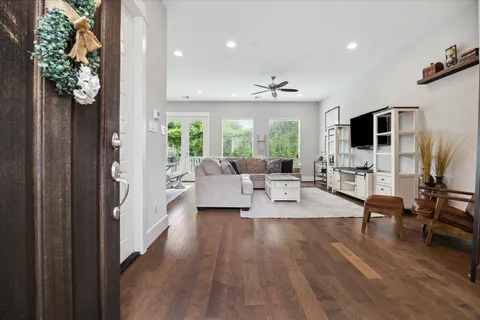 a living room with furniture and a flat screen tv
