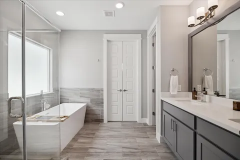 a bathroom with a bathtub and a shower