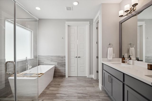 a bathroom with a bathtub and a shower