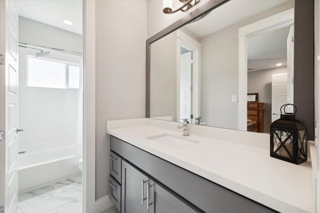a view of a backyard with a plants and wooden fence
