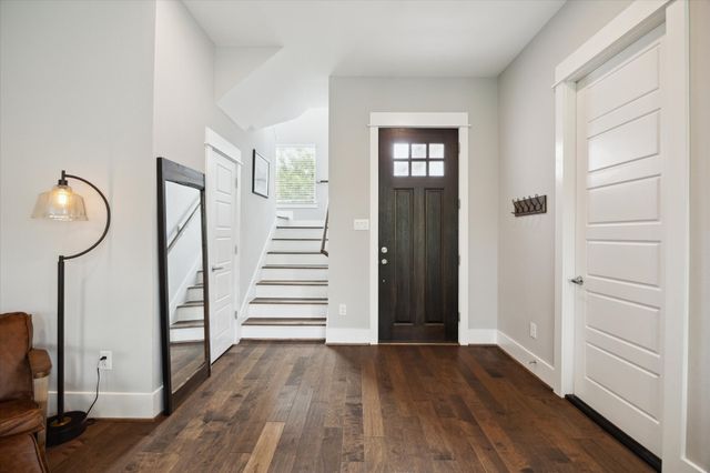 a view of a room with wooden floor and windows