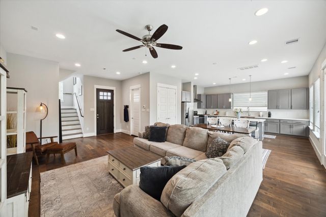 a living room with furniture and kitchen view