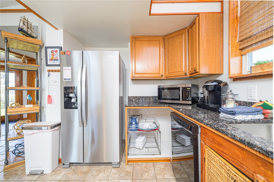 108 North 2nd Street Fulton, TX 78382 - Photo 15 of 23 a kitchen with stainless steel appliances granite countertop a refrigerator and a sink