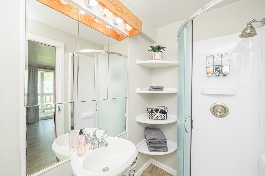 108 North 2nd Street Fulton, TX 78382 - Photo 17 of 23 a bathroom with a sink a toilet and shower curtain
