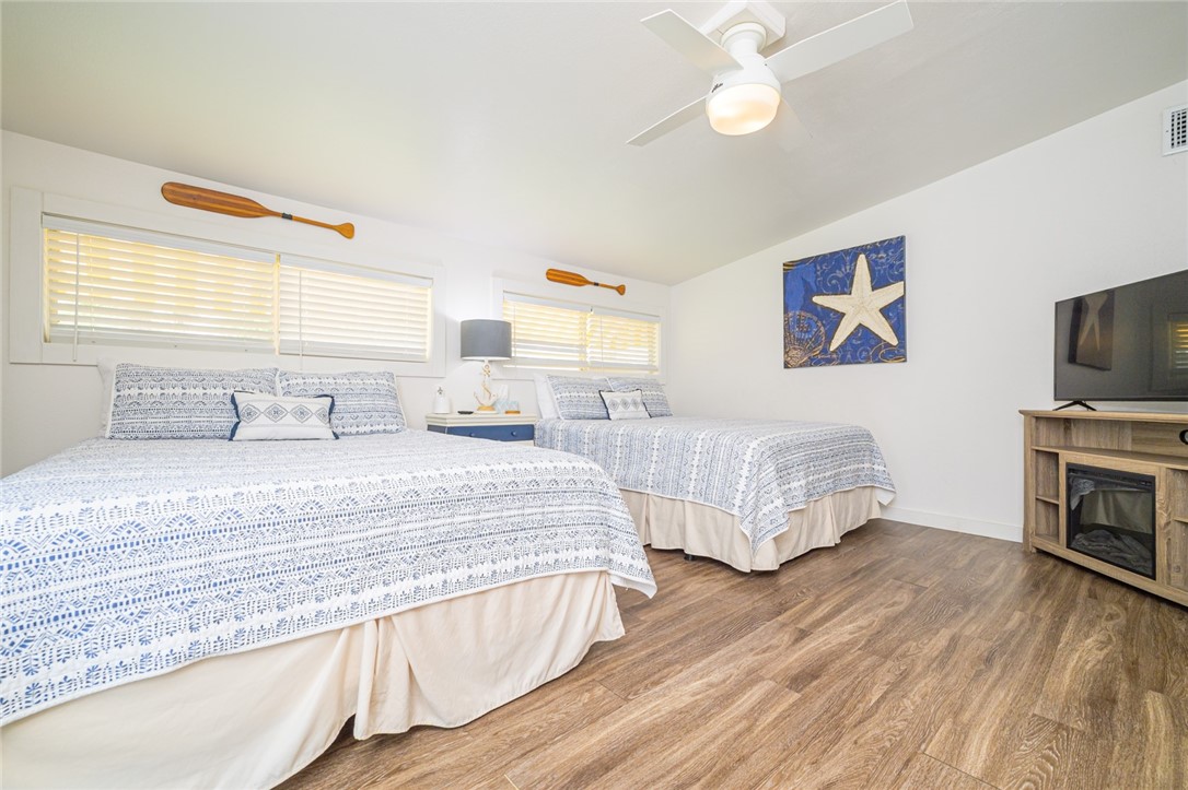 108 North 2nd Street Fulton, TX 78382 - Photo 19 of 23 a bedroom with double bed and a tv