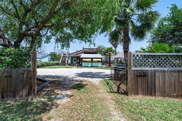a view of a backyard with sitting area