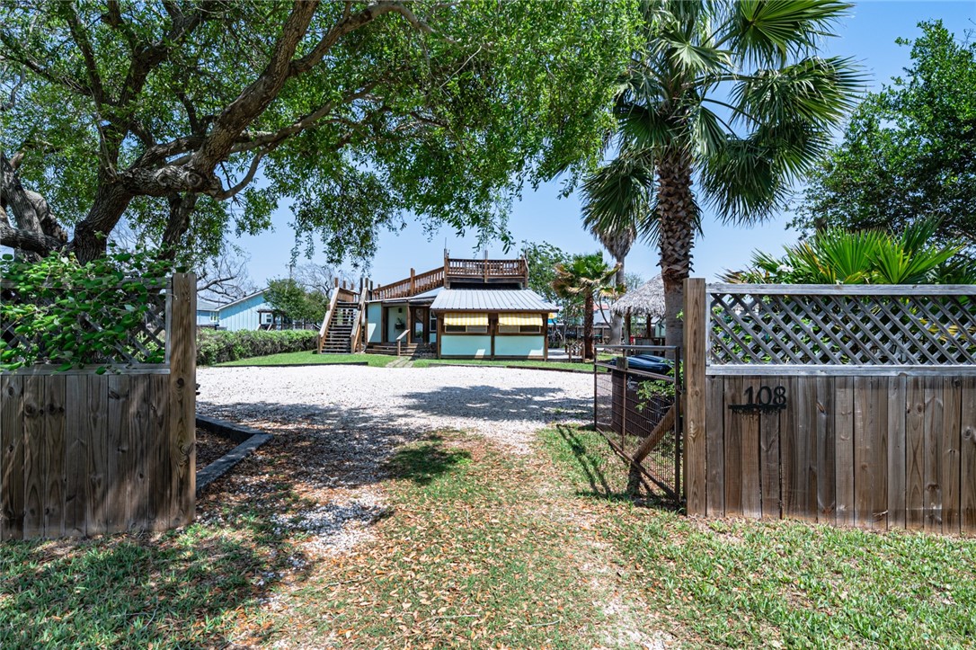108 North 2nd Street Fulton, TX 78382 - Photo 3 of 23 a front view of a house with a garden