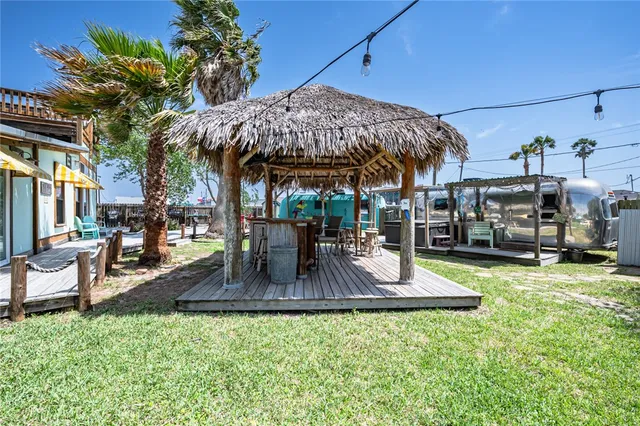 a backyard of a house with barbeque oven table and chairs