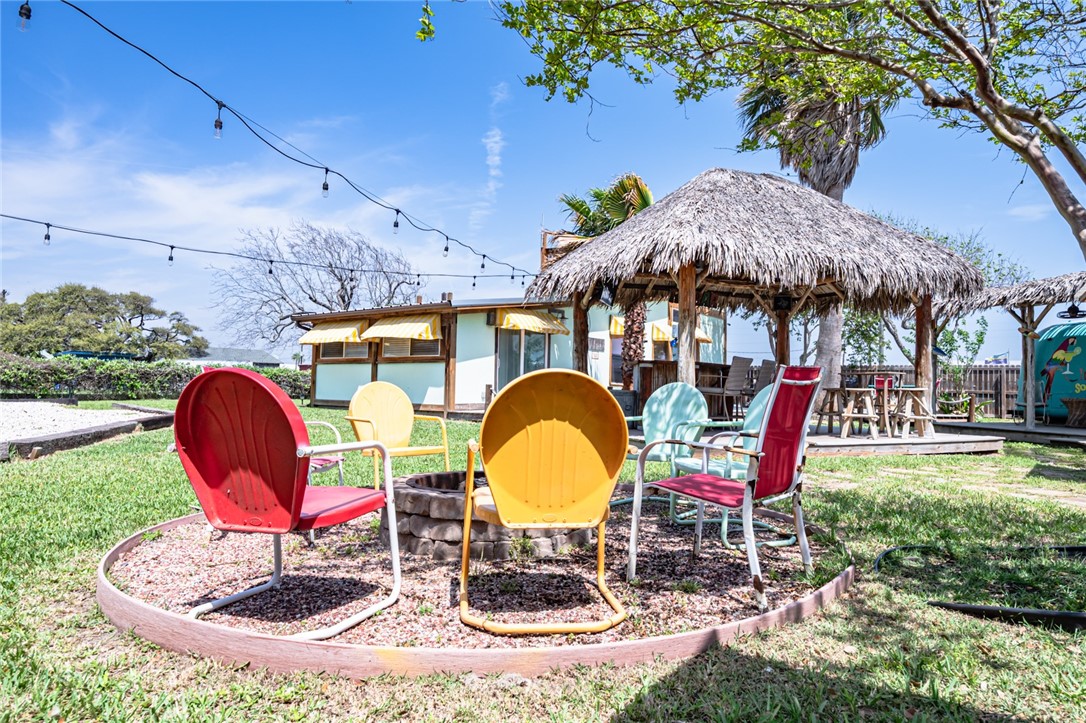 108 North 2nd Street Fulton, TX 78382 - Photo 7 of 23 a backyard of a house with table and chairs