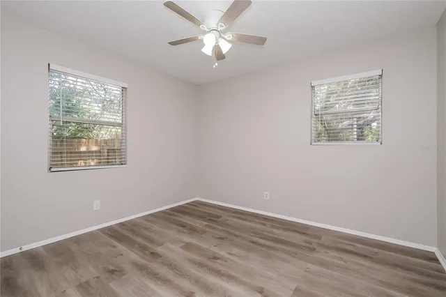 a view of a room with a ceiling fan and a window