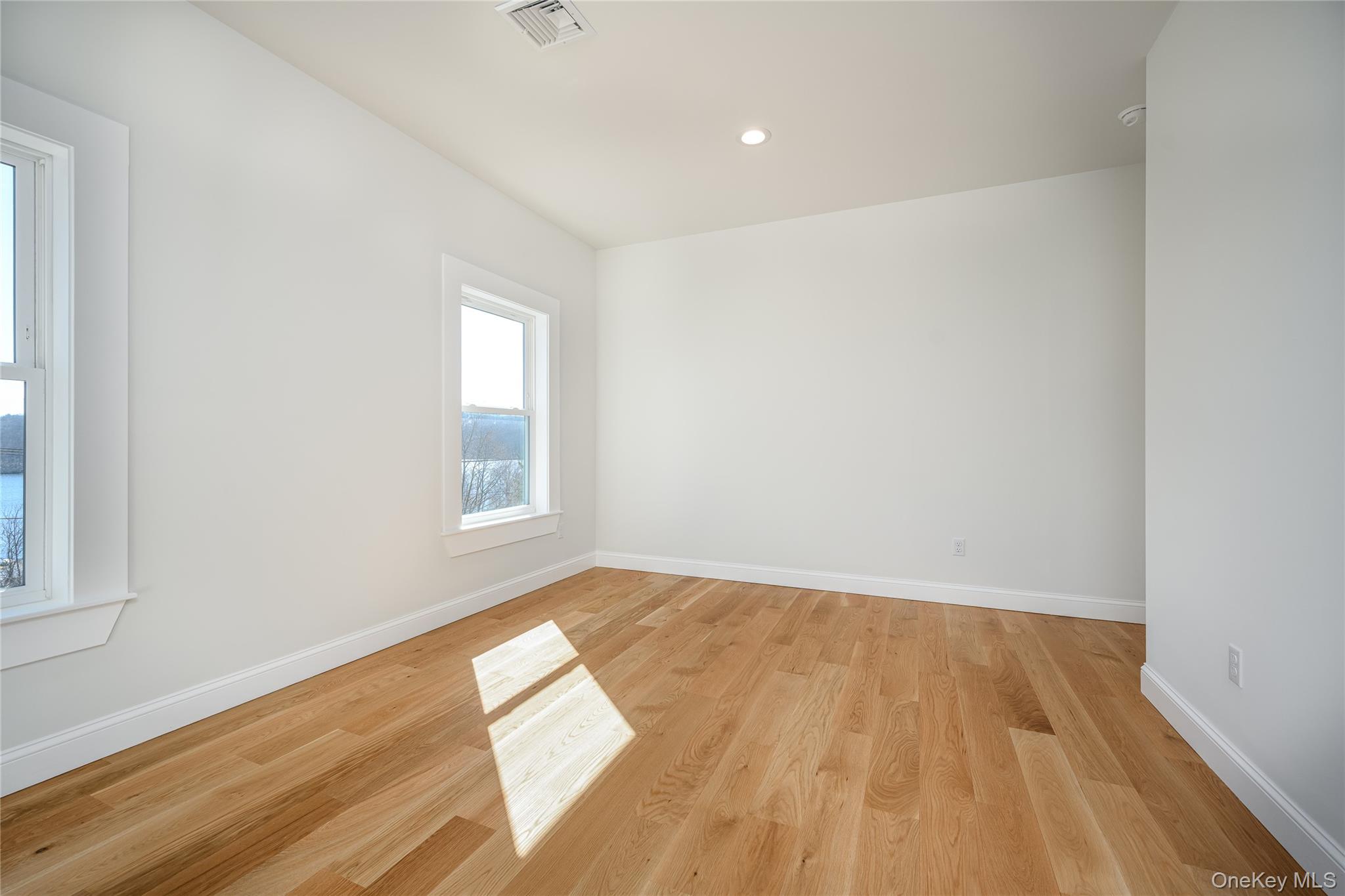 133 West Mombasha Road Monroe, NY 10950 - Photo 41 of 47 an empty room with wooden floor and windows