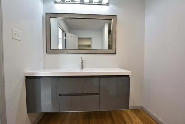 a bathroom with a sink and a mirror