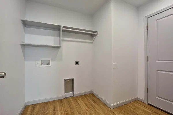 a view of a room with wooden floor and closet