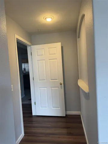 an empty room with wooden floor and closet