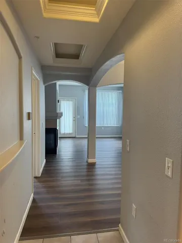 a view of a hallway view with wooden floor and staircase
