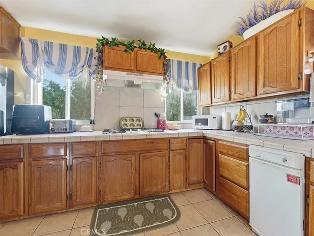a kitchen with a sink window and cabinets