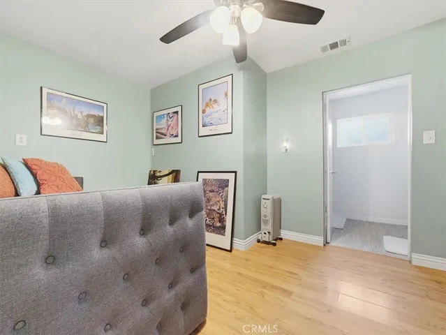 a bed room with a bed and a painting on the wall