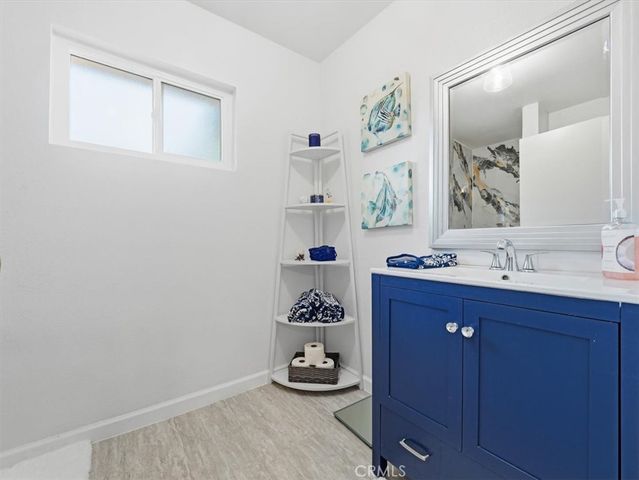 a bathroom with a sink a vanity and a mirror