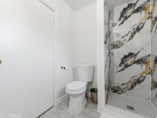 a bathroom with a toilet and a shower
