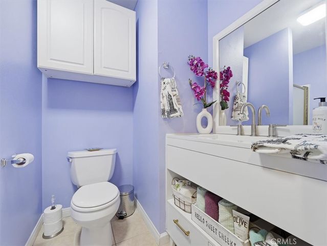 a view of a livingroom with furniture and a refrigerator