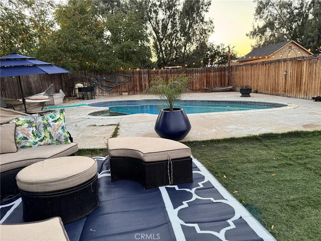 a view of a backyard with sitting area