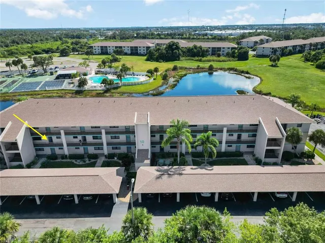 an aerial view of a house with a garden and lake view