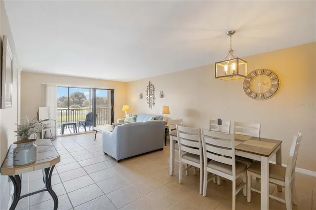 a view of a dining room with furniture wooden floor and a chandelier