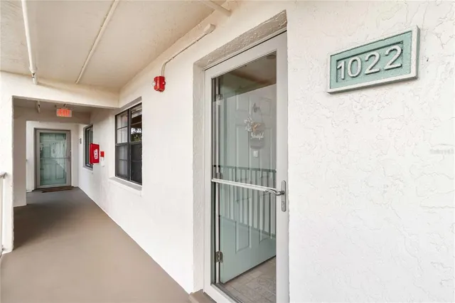 a view of a hallway with wooden shelves
