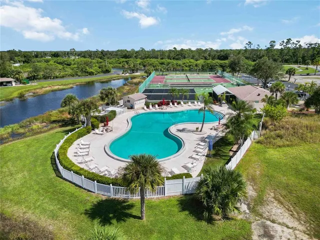 an aerial view of a house with garden space seating space and lake view