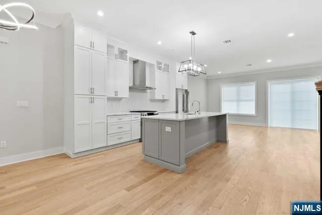 a kitchen with a sink and wooden floor