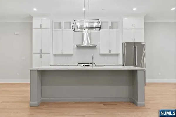 a kitchen with stainless steel appliances granite countertop a refrigerator a sink and a stove