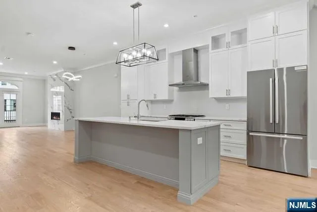 a kitchen with stainless steel appliances granite countertop a stove and a sink