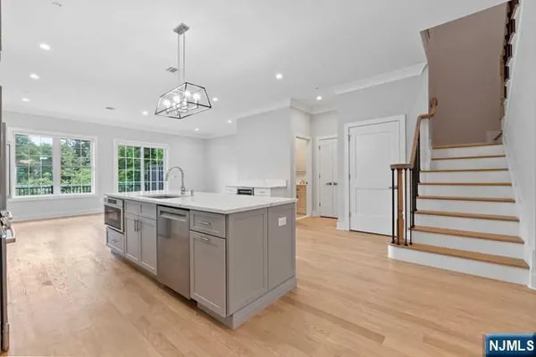 a large kitchen with cabinets and stainless steel appliances