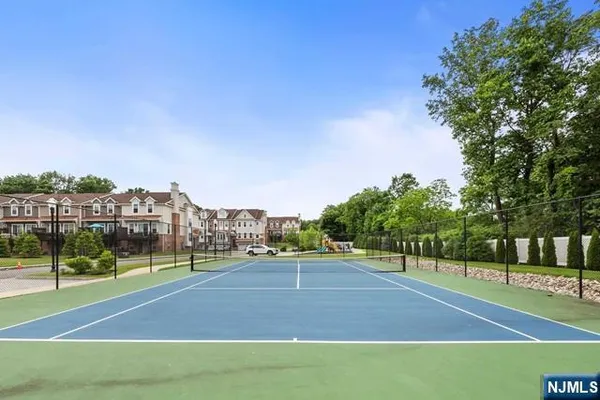 a view of a house with pool and chairs