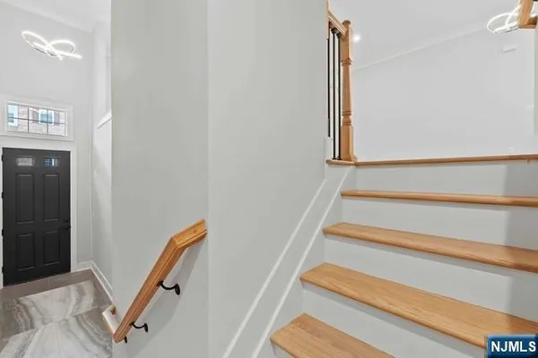 a view of an empty room with furniture and floor to ceiling window