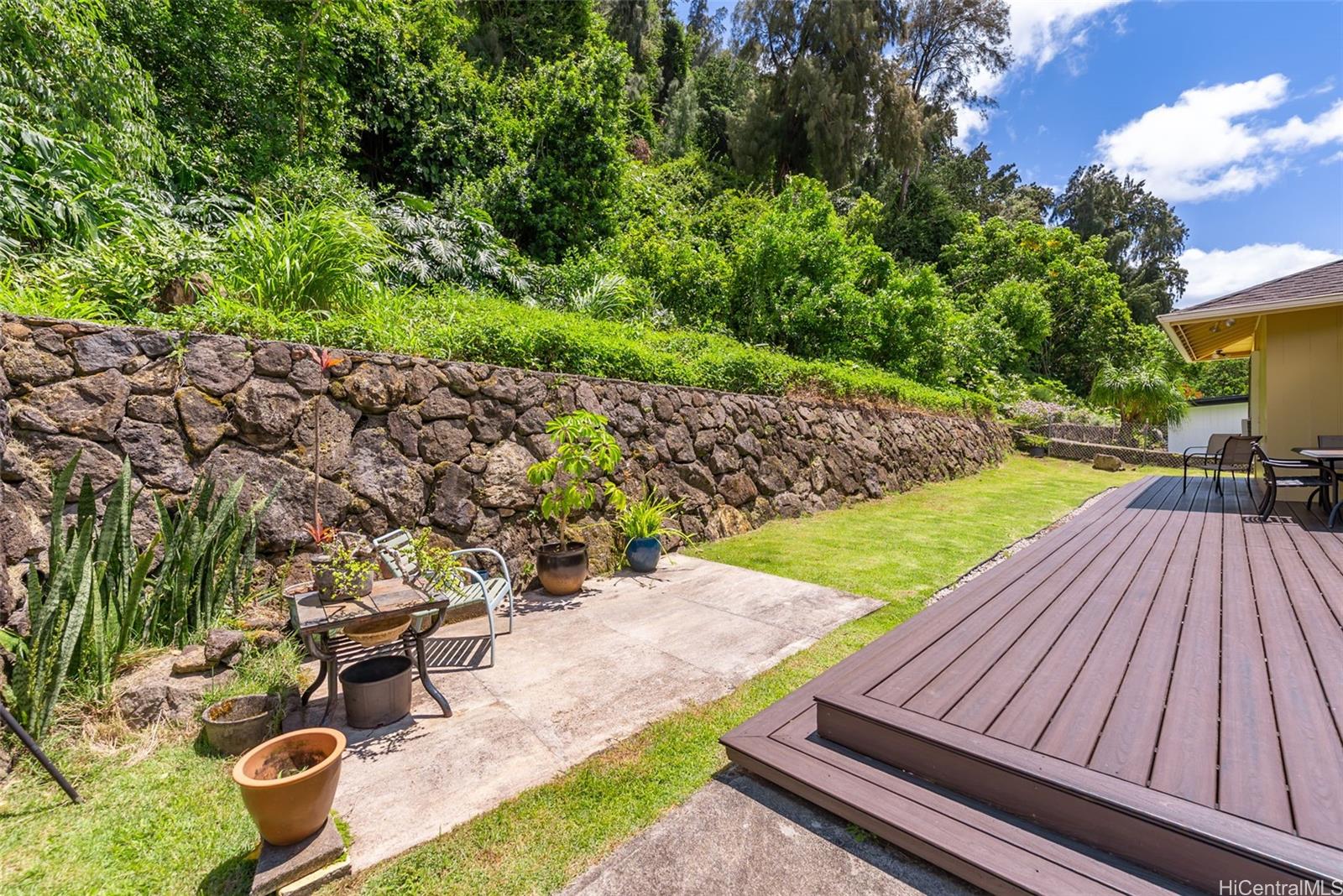 2811 Henry Street Honolulu, HI 96817 - Photo 8 of 25 A true backyard retreat! The gently sloping lawn and striking lava rock wall provide a dramatic, private backdrop for your everyday island lifestyle
