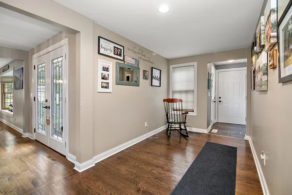a view of a livingroom with wooden floor and a furniture