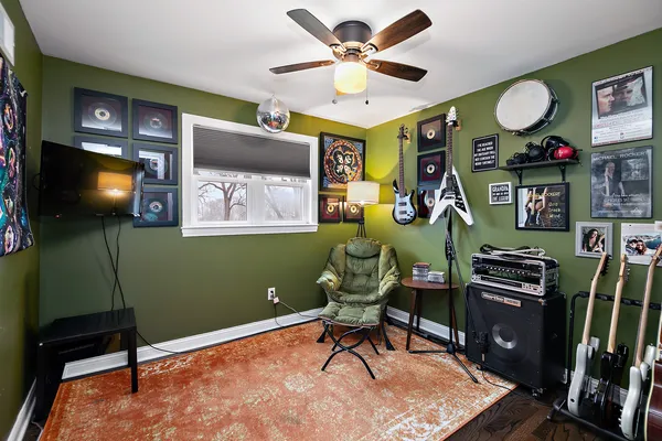a living room with furniture a flat screen tv and a bookshelf
