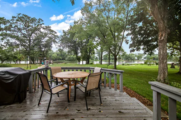 a view of a dinning table and chairs on the deck