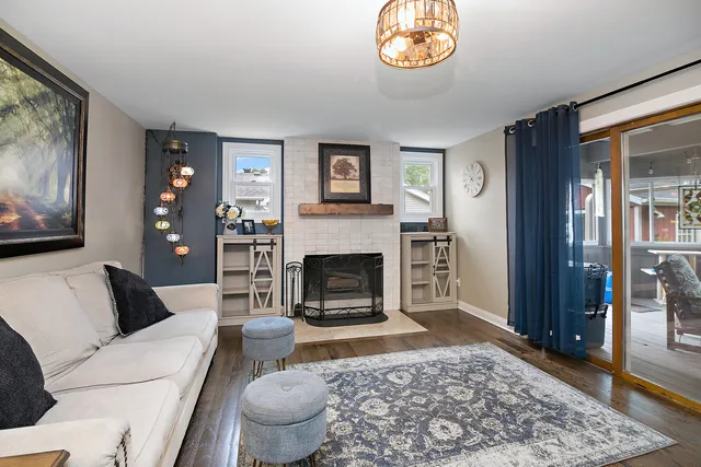 a living room with furniture a chandelier and a table