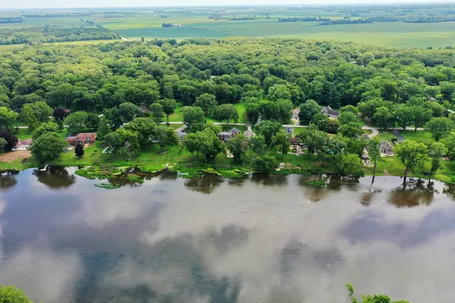 an aerial view of a houses with a yard