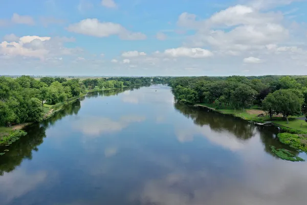 an aerial view of a house with garden space and lake view