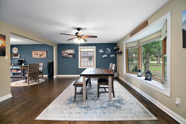 a view of a dining room with furniture window and wooden floor