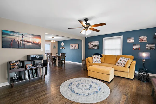 a living room with furniture and wooden floor