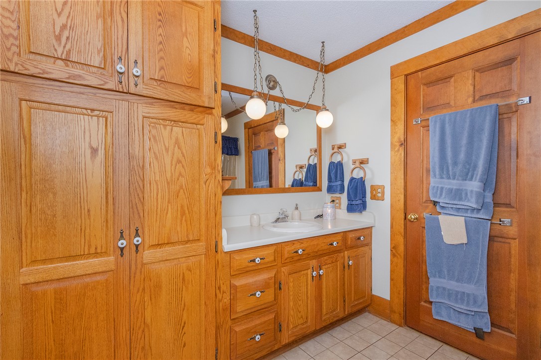 911 State Rd S-4-203 Belton, SC 29627 - Photo 27 of 49 Custom cabinetry and warm wood accents define this inviting bathroom vanity space.