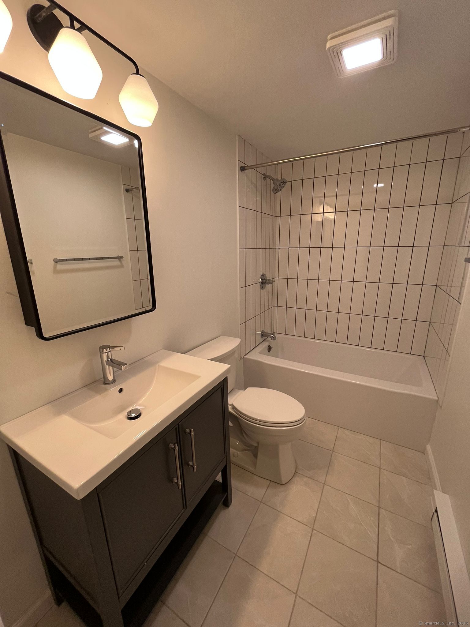 a bathroom with a sink a toilet and mirror