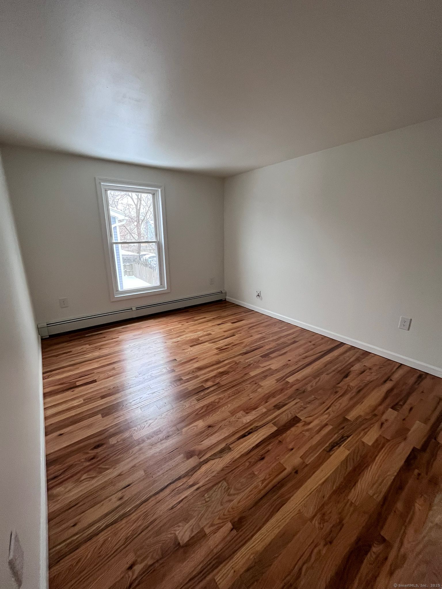 46 Orchard Street, Unit 52C New Haven, CT 06519 - Photo 2 of 12 an empty room with wooden floor and windows