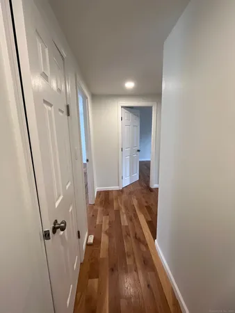 a view of a hallway and wooden floor