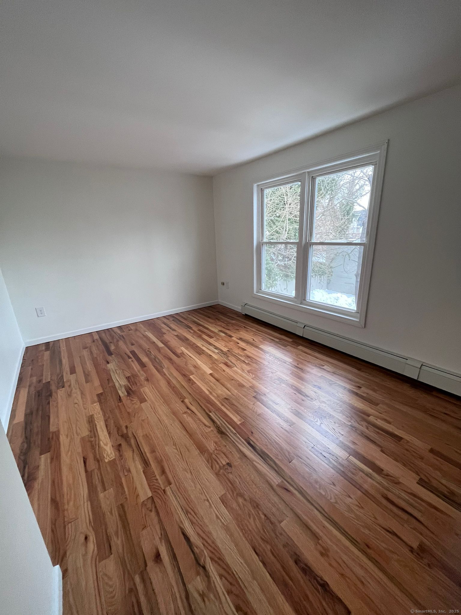 46 Orchard Street, Unit 52C New Haven, CT 06519 - Photo 5 of 12 a view of a room with wooden floor and windows